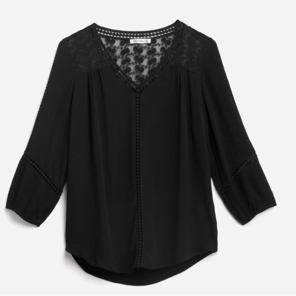 Flowy v-neck top featuring lace/crochet detailing.